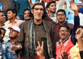 8-feet tall Afghan cricket fan Sher Khan watches the one-day international cricket series between Afghanistan and West Indies, in Lucknow, Wednesday, Nov. 6, 2019. (PTI Photo) 