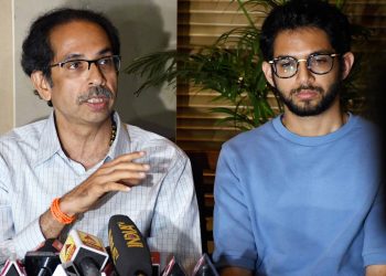 Shiv Sena chief Uddhav Thackeray addresses a press conference as his son and Yuva Sena chief Aaditya Thackeray looks on