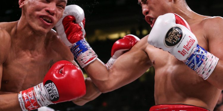 December 20, 2019; Phoenix, AZ, USA; Julio Cesar Martinez Aguilar and Cristofer Rosales during their December 20, 2019 Matchroom Boxing USA bout at the Talking Stick Resort Arena in Phoenix, AZ.  Mandatory Credit: Ed Mulholland/Matchroom Boxing USA