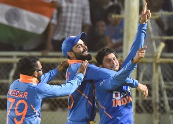 Kildeep Yadav celebrates with Virat Kohli and Kedar Jadhav after his hat-trick against the West Indies Wednesday