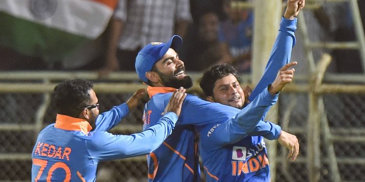 Kildeep Yadav celebrates with Virat Kohli and Kedar Jadhav after his hat-trick against the West Indies Wednesday