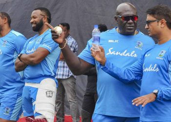 Kieron Pollard (2nd left) has a laugh with Phil Simmons