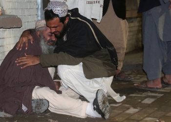 Men comfort each other as they mourn the death of a relative who was killed in a bomb blast in a mosque, at a hospital morgue in Quetta, Pakistan January 10, 2020. REUTERS/Naseer Ahmed