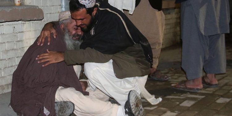 Men comfort each other as they mourn the death of a relative who was killed in a bomb blast in a mosque, at a hospital morgue in Quetta, Pakistan January 10, 2020. REUTERS/Naseer Ahmed