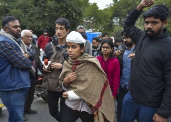 An injured Aishe Ghosh minutes before her press conference Monday