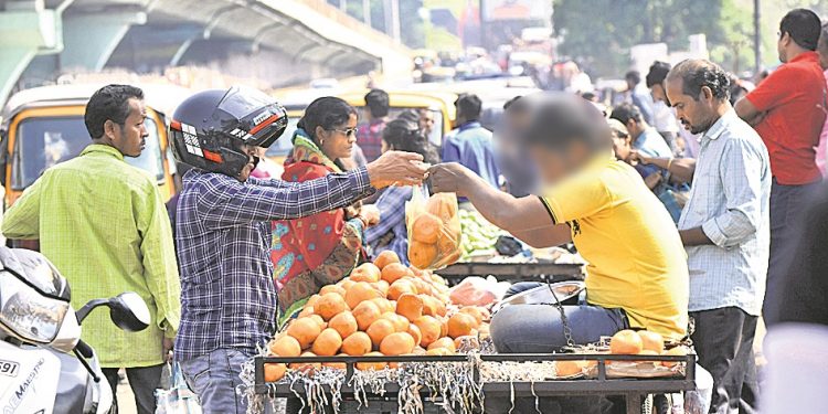 A vendor sells fruits in a polythene bag in Bhubaneswar