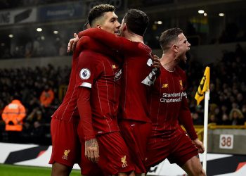 Liverpool players celebrate with Roberto Firmino (2nd left) after he scored the winning goal Thursday