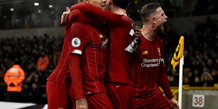 Liverpool players celebrate with Roberto Firmino (2nd left) after he scored the winning goal Thursday