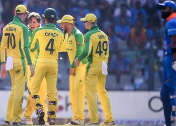 Australian players celebrate with bowler Adam Zampa after Virat Kohli's dismissal, Tuesday