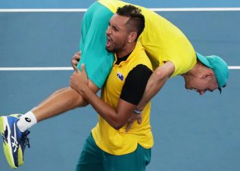 Nick Kyrgios celebrates with a teammate after Australia's win