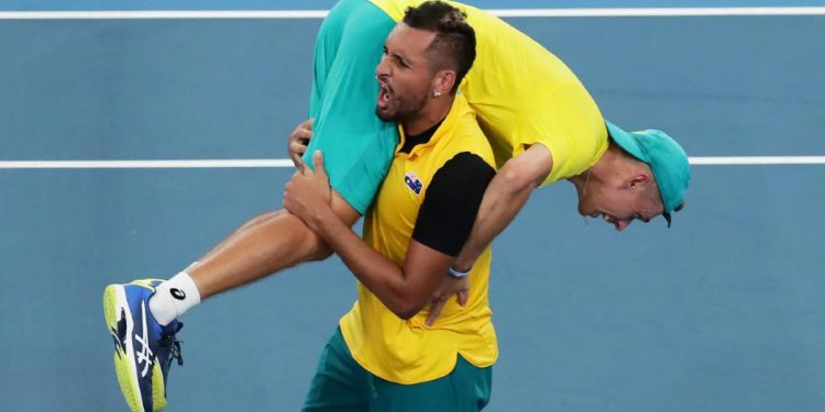 Nick Kyrgios celebrates with a teammate after Australia's win