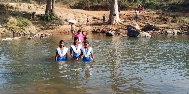 Crossing river routine for these school-going kids