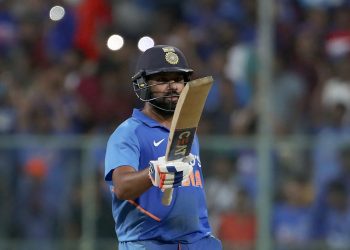 Rohit Sharma raises his bat after reaching his century at Bangalore against Australia