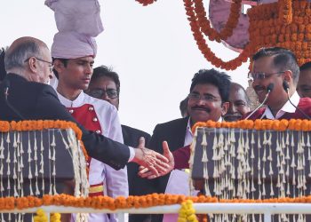 Delhi Lieutenant Governor Anil Baijal congratulates Arvind Kejriwal after the swearing in ceremony