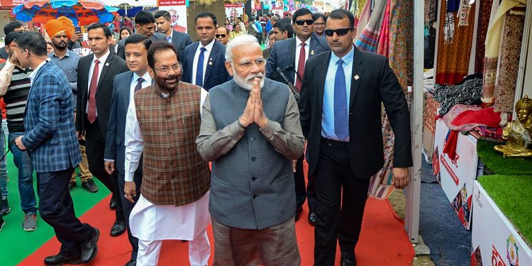 Prime Minister Narendra Modi with Minority Affairs Minister Mukhtar Abbas Naqvi during a surprise visit to 'Hunar Haat'