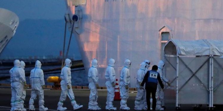 Officers in protective gear enter the cruise ship Diamond Princess, where 10 more people were tested positive for coronavirus on Thursday, to transfer a patient to the hospital after the ship arrived at Daikoku Pier Cruise Terminal in Yokohama, south of Tokyo, Japan February 7, 2020. REUTERS/Kim Kyung-Hoon REFILE - ADDING INFORMATION