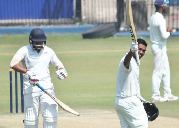 Debashis Samantray acknowledges the applause after reaching his hundred against Jharkhand