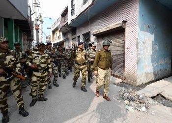 Security forces conduct a flag march at the Jaffrabad area