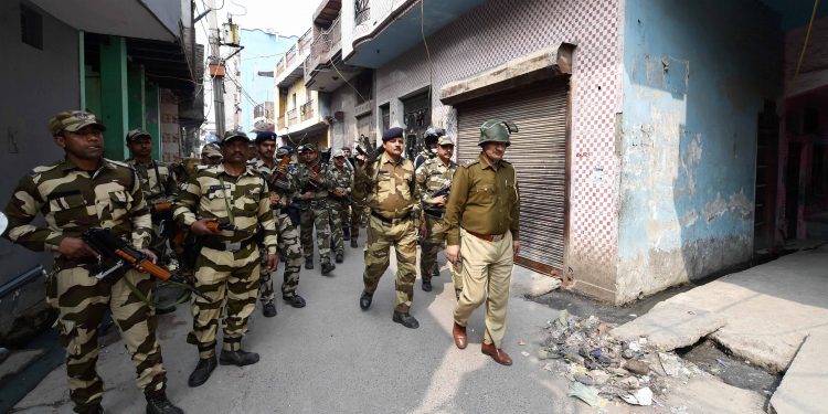 Security forces conduct a flag march at the Jaffrabad area