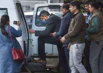 Bookie Sanjeev Chawla (wearing face mask) being escorted by police officials