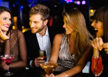 Man talking to women at bar