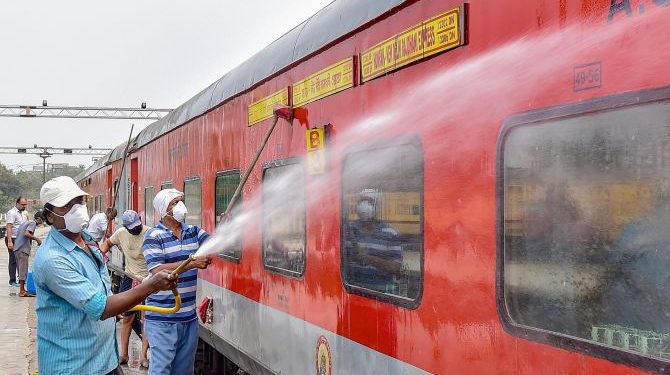 Kolkata: Railway workers spray disinfectant on Howrah-New Delhi Rajdhani Express train in the wake of coronavirus pandemic, at a railway yard in Kolkata, Monday, March 16, 2020. (PTI Photo/Swapan Mahapatra)(PTI16-03-2020_000096B)