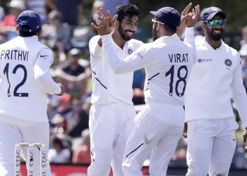 Jasprit Bumrah celebrates with teammates after dismissing a New Zealand batsman