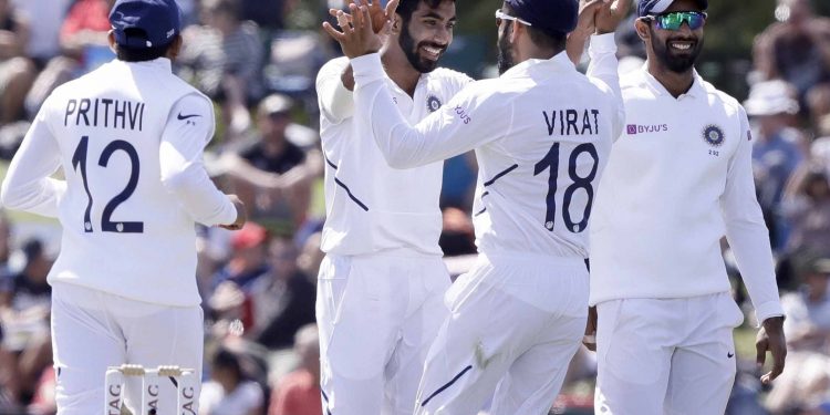 Jasprit Bumrah celebrates with teammates after dismissing a New Zealand batsman