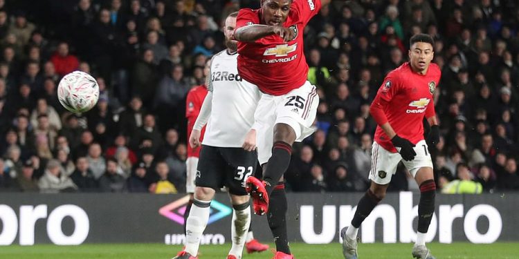 Odion Ighalo scores his second goal against Derby county as former Man U legend Wayne Rooney (32) watches