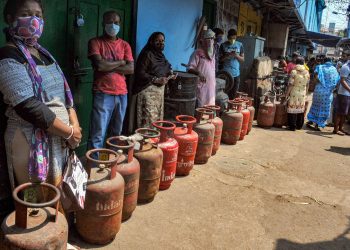 People queue up for LPG cylinders at a shop in Kolkata