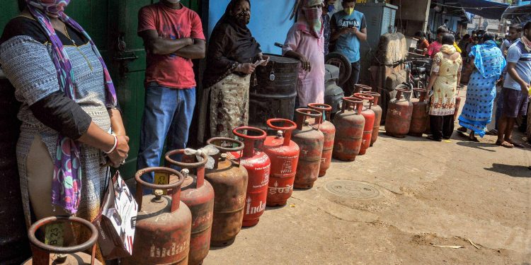 People queue up for LPG cylinders at a shop in Kolkata