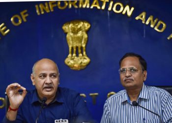 Delhi Deputy Chief Minister Manish Sisodia addresses a press conference as Health Minister Satyendra Jain (R) looks on