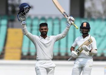 Arpit Vasavada raises his bat after century as Cheteshwar Pujara appreciates in Rajkot, Tuesday