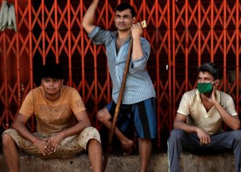 Migrant workers, who work in textile looms, are seen outside a loom after it was shut due to nationwide lockdown to slow the spread of the coronavirus disease, in Bhiwandi on the outskirts of Mumbai (Photo: Reuters/Francis Mascarenhas)