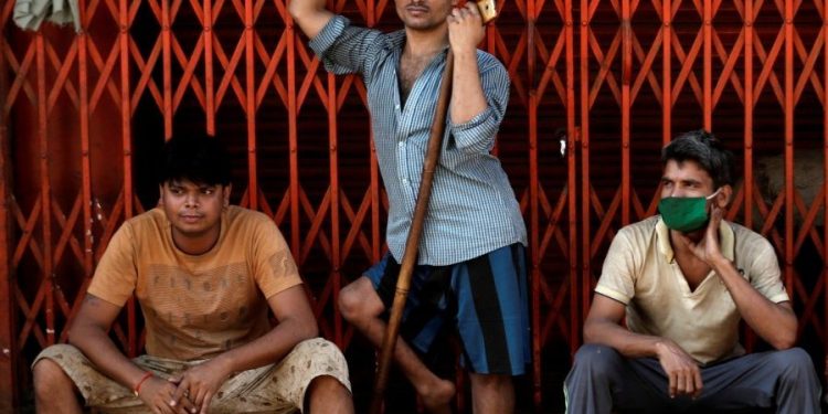 Migrant workers, who work in textile looms, are seen outside a loom after it was shut due to nationwide lockdown to slow the spread of the coronavirus disease, in Bhiwandi on the outskirts of Mumbai (Photo: Reuters/Francis Mascarenhas)