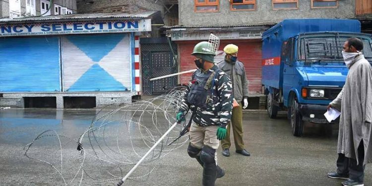 A man requests security personnel to let him pass a barricade during the nationwide lockdown imposed in the wake of coronavirus pandemic in Srinagar. (File photo. PTI)