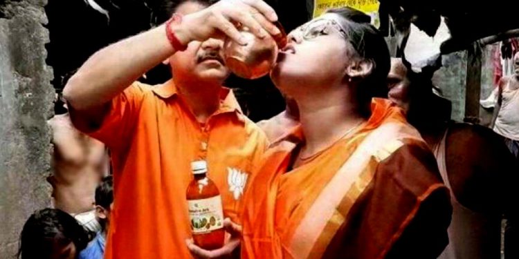 Cow urine being given to a devotee in Kolkata