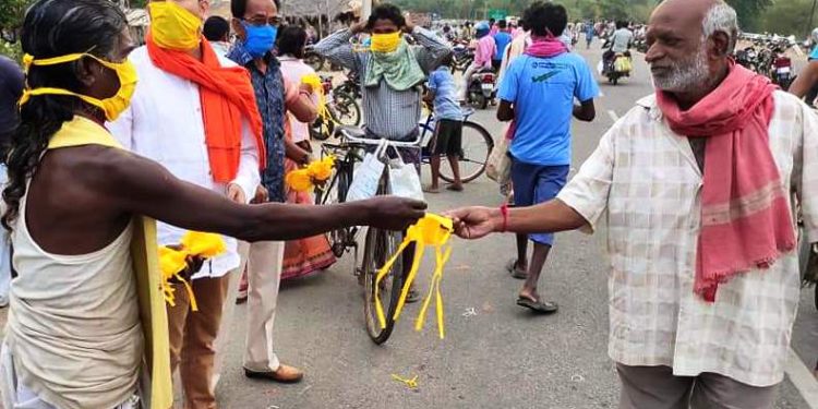 Poet Haldhar Nag distributing masks Thursday