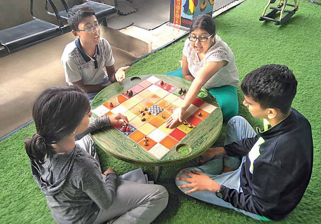 familes playing indor games-ludo- together (1)