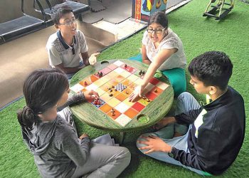 familes playing indor games-ludo- together (1)