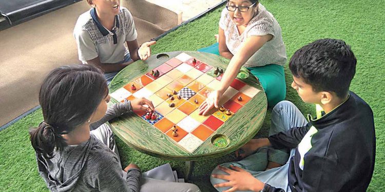 familes playing indor games-ludo- together (1)