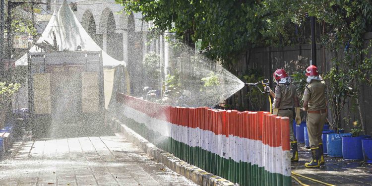 Firefighters spray disinfectants at a locality near Nizamuddin mosque, Thursday