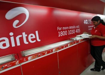 An employee checks a customers' feedback book next to a Bharti Airtel logo inside its shop in Kolkata May 2, 2012. REUTERS/Rupak De Chowdhuri/Files