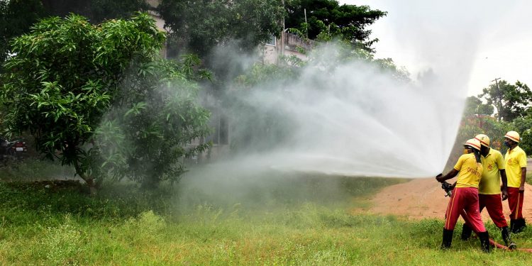 Fire brigade personnel conduct a mock drill at a fire station at Kalpana Square in Bhubaneswar, Wednesday, to deal with possible locust attacks in state