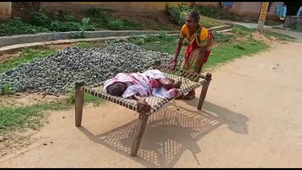 Woman drags cot with ailing centenarian mother on to the bank for Rs.1500