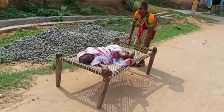 Woman drags cot with ailing centenarian mother on to the bank for Rs.1500
