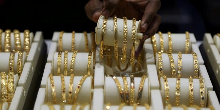 A salesman arranges gold bangles inside a jewellery showroom. (File photo, Reuters)
