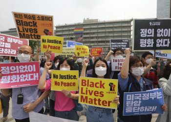 Seoul: South Korean protesters shout slogans during a protest over the death of George Floyd, a black man who died after being restrained by Minneapolis police officers on May 25, near the U.S. embassy in Seoul, South Korea, Friday, June 5, 2020. The signs read "The U.S. government should stop oppression and there is no peace without justice." AP/PTI
