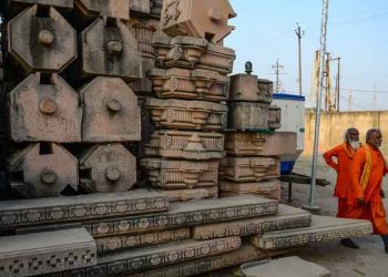 File photo of Hindu devotees walking past stone slabs earmarked for the construction of Ram temple at Ram Janmabhoomi Nyas workshop in Ayodhya (Source: AFP)