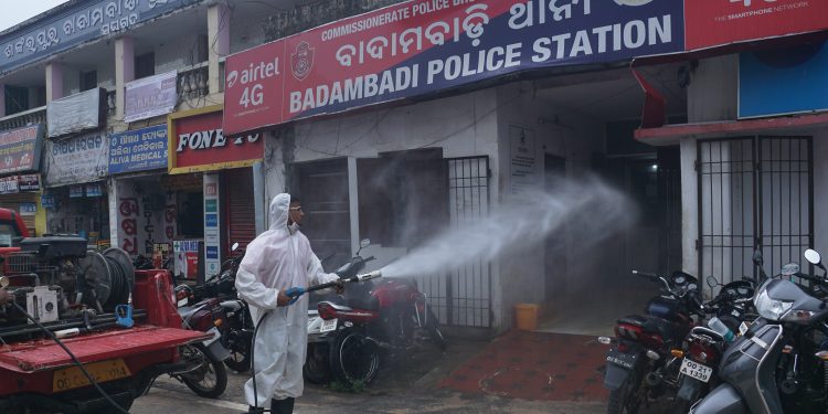 A Fire Service personnel sanitises Badambadi police station in Cuttack, Sunday